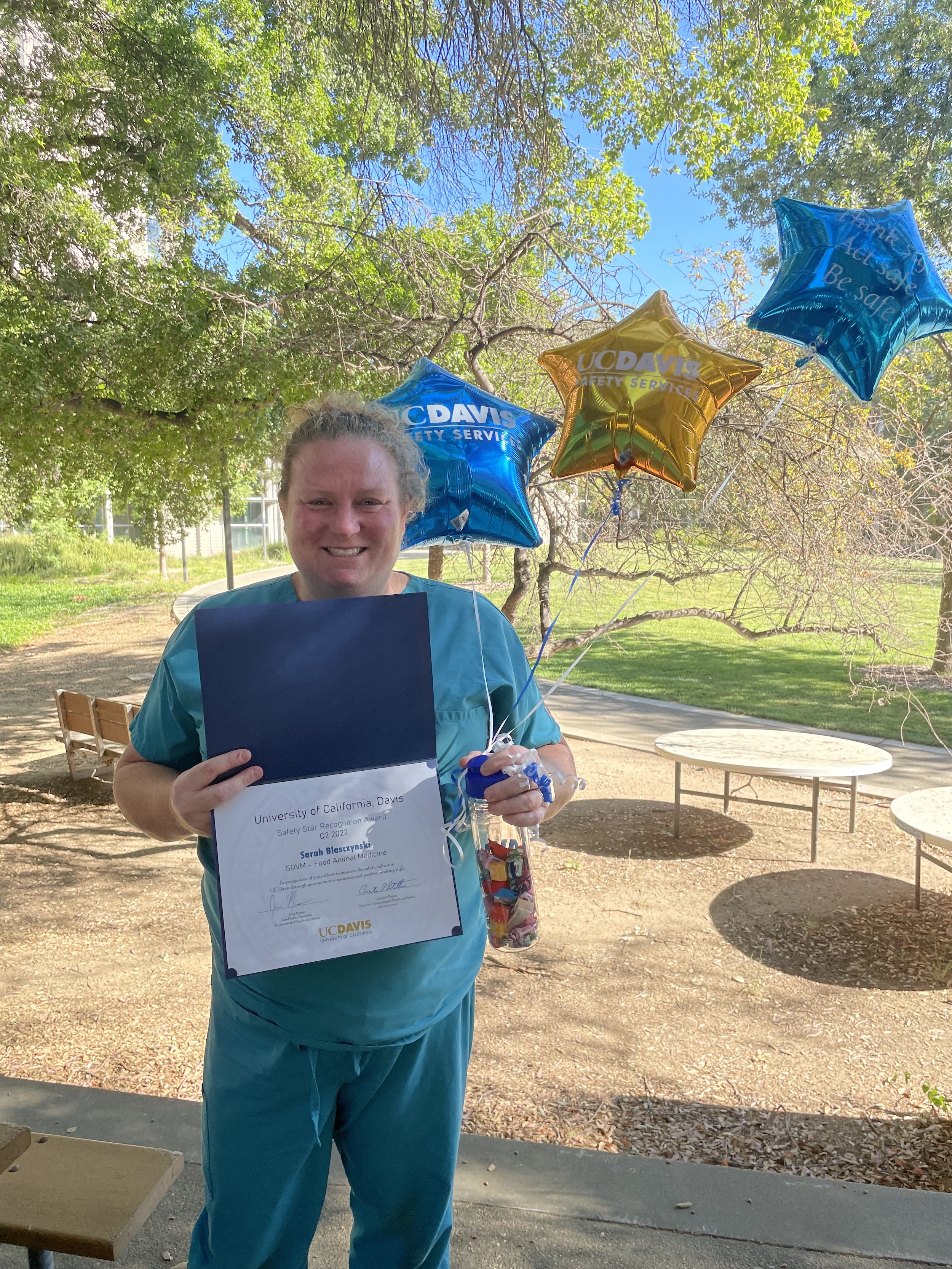 Sarah Blasczynski standing outside with balloons and Safety Star Award