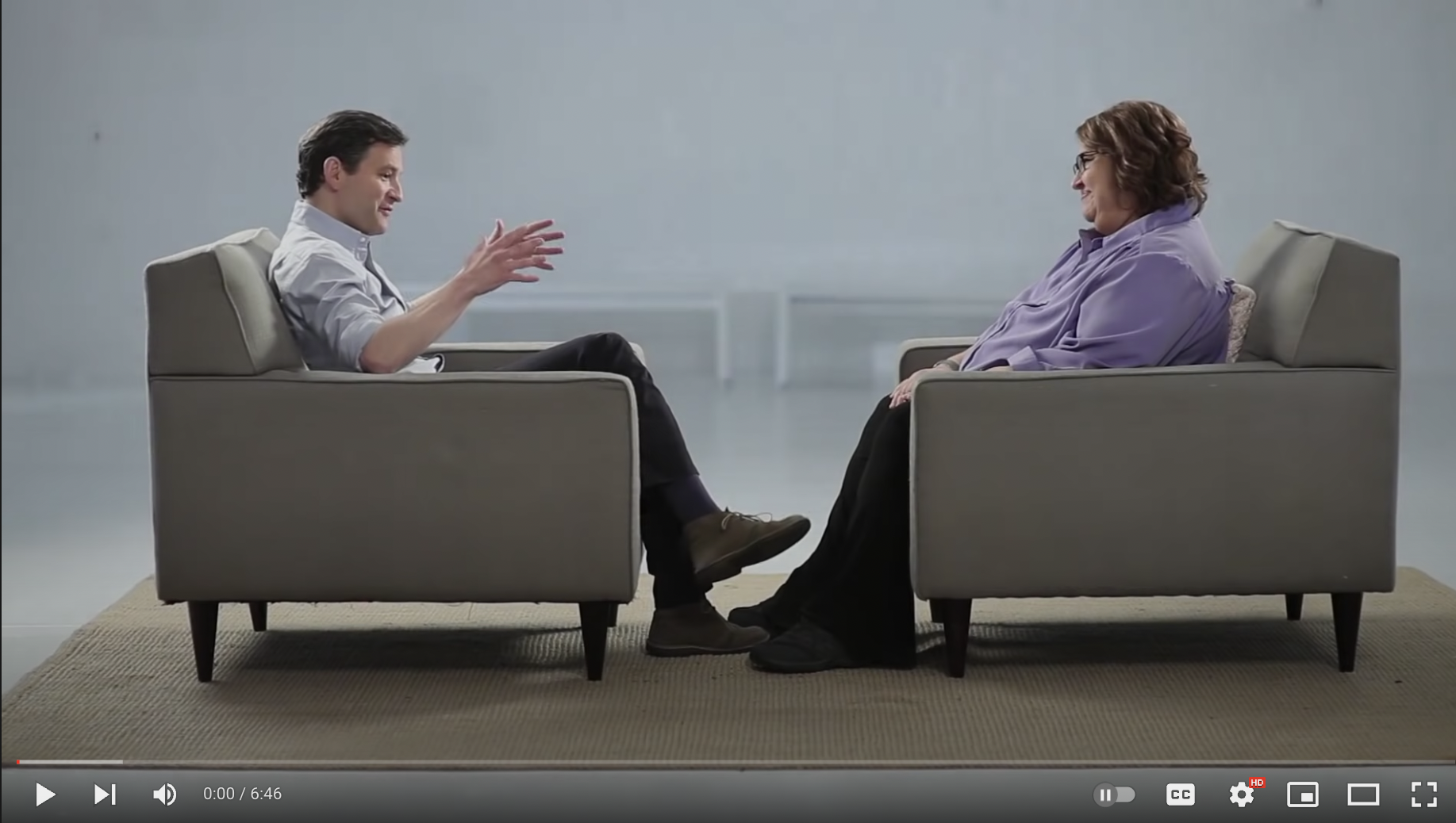 Sharon Salzberg and a colleague talking in chairs facing each other 