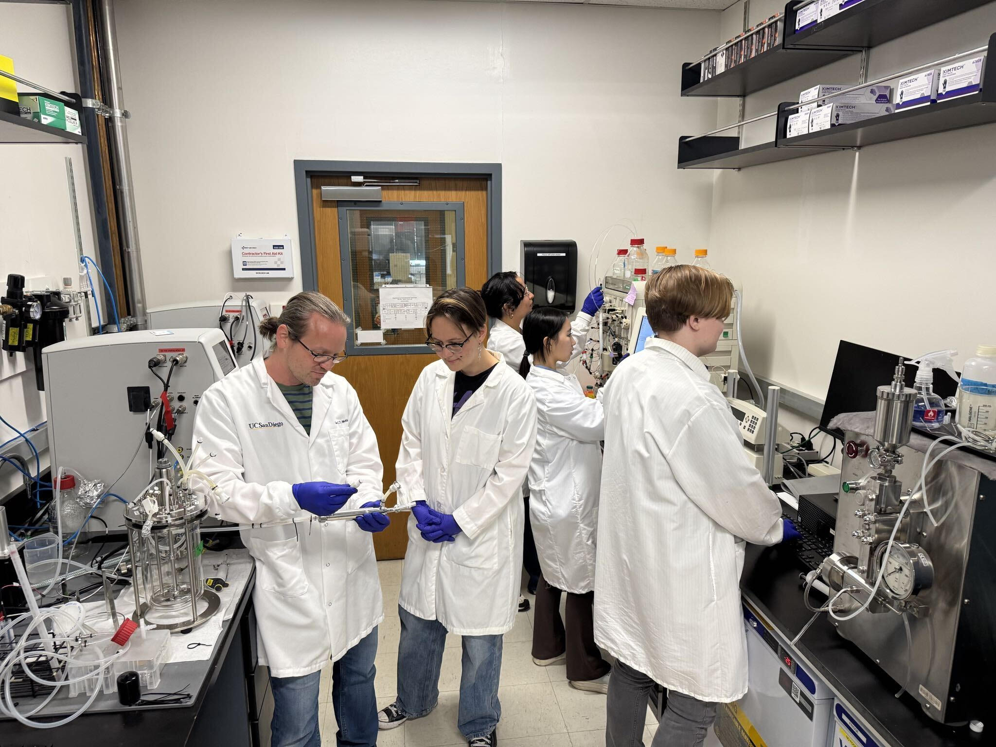 Dr. Nicklisch and his lab members operate machinery.