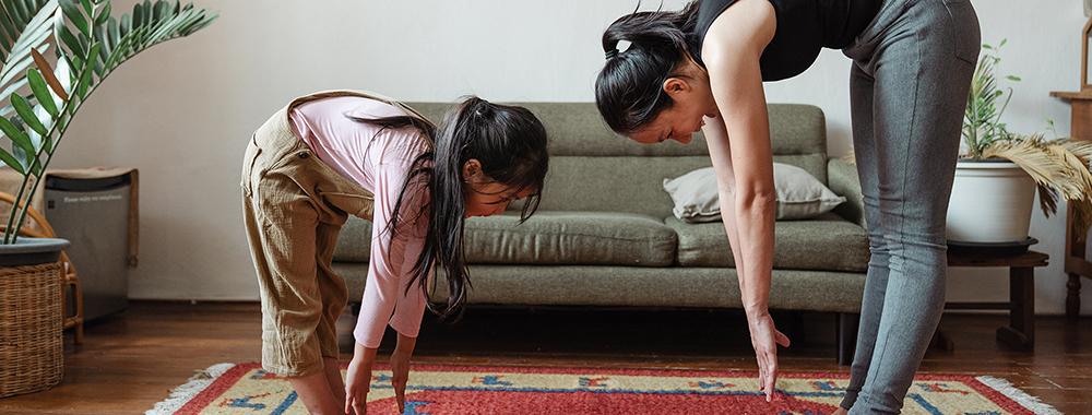 mother and child doing yoga in their house