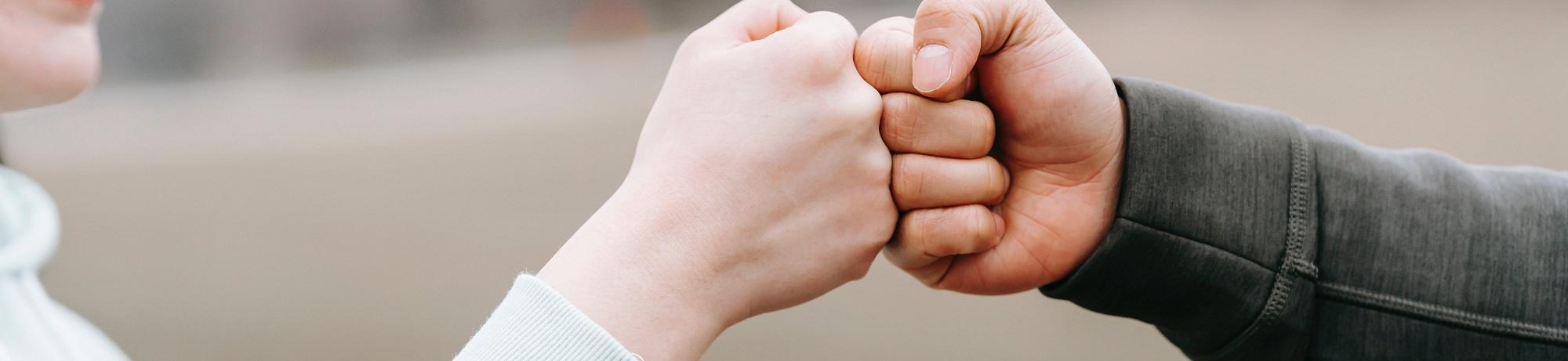two hands in a fist bump 