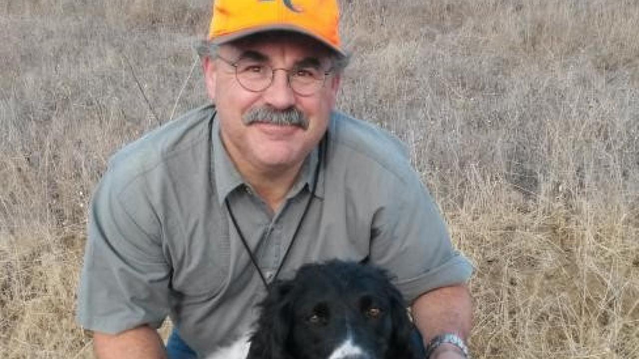 Andrew posing with his dog after a successful hunt. 