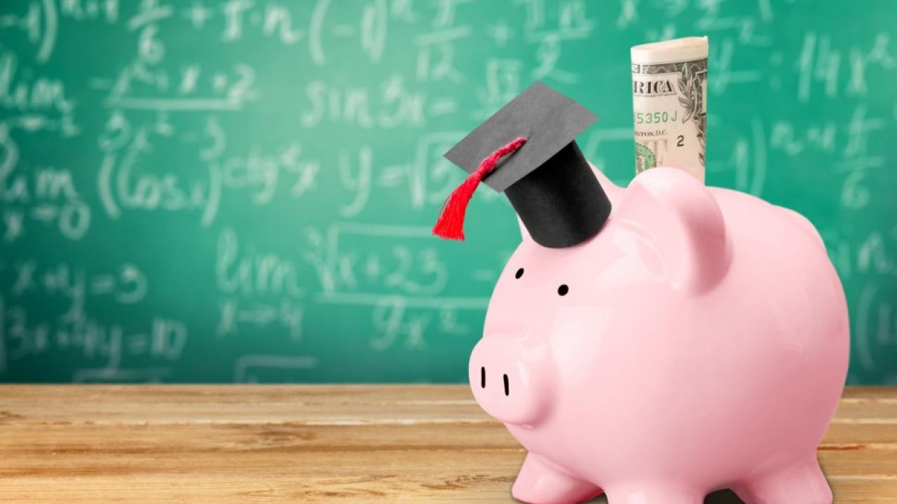 a piggy bank wearing a graduation cap