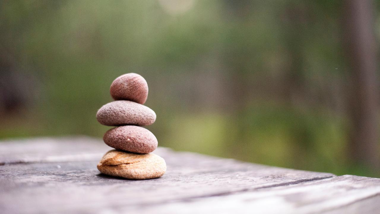 Four rocks stacked and balanced on top of each other.