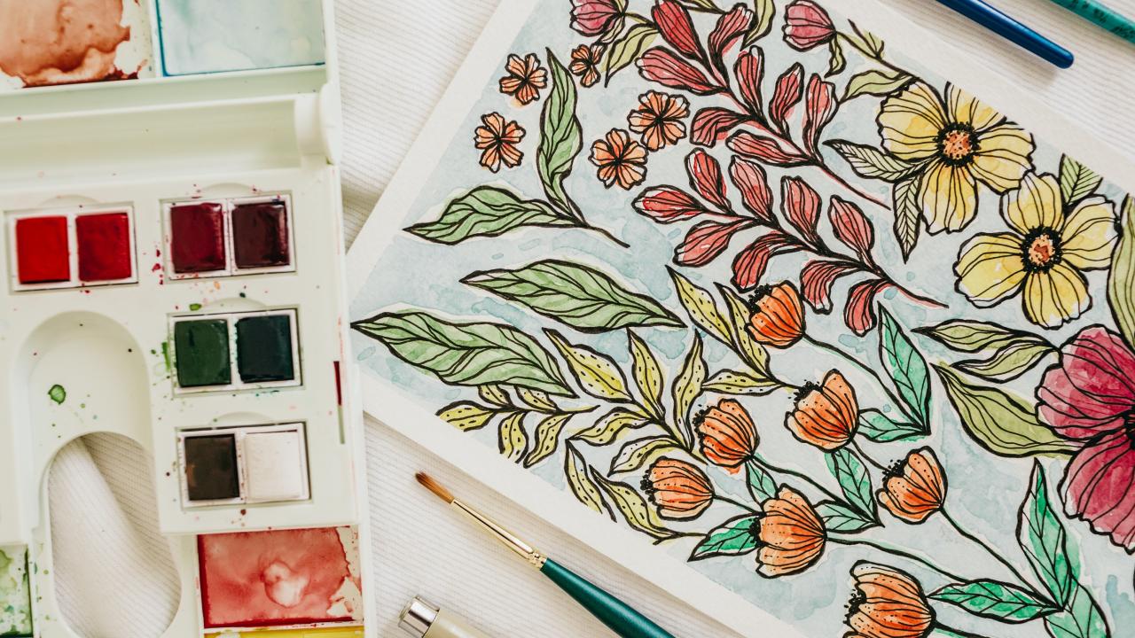 image of watercolor palette and artwork of flowers
