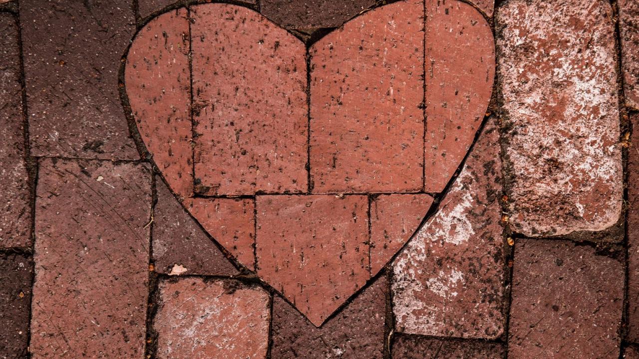 red brick path with a bricks laid in a heart shape pattern