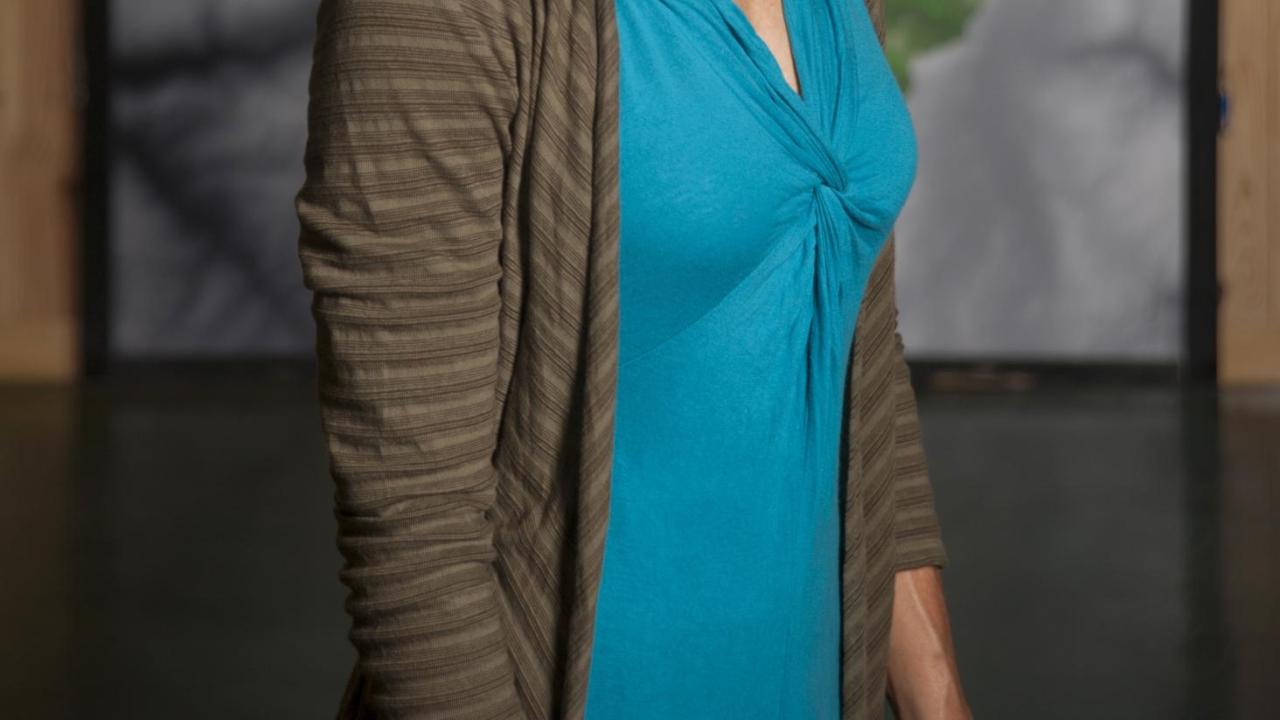 Heather Segale in front of grey, green, and blue background
