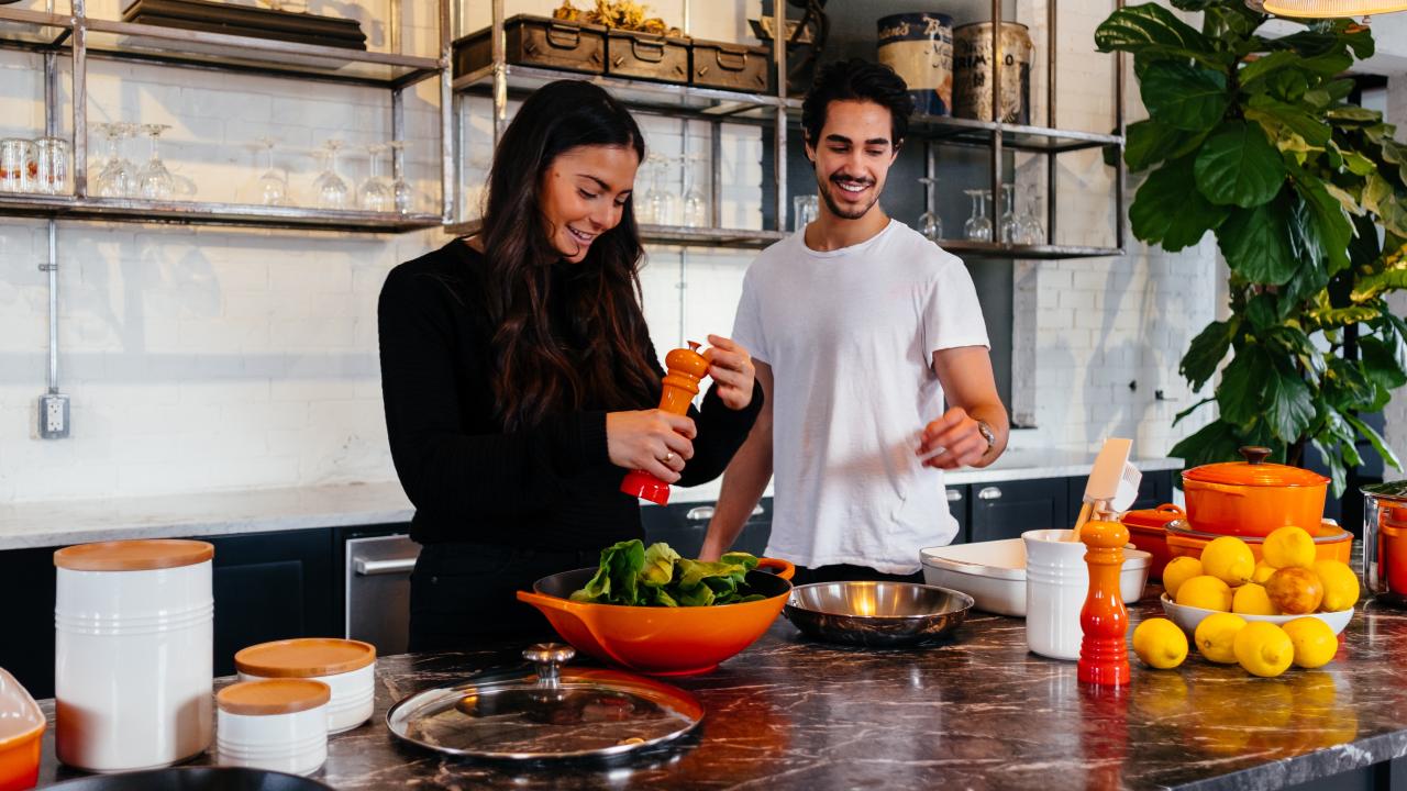 Man and Woman cooking together happily