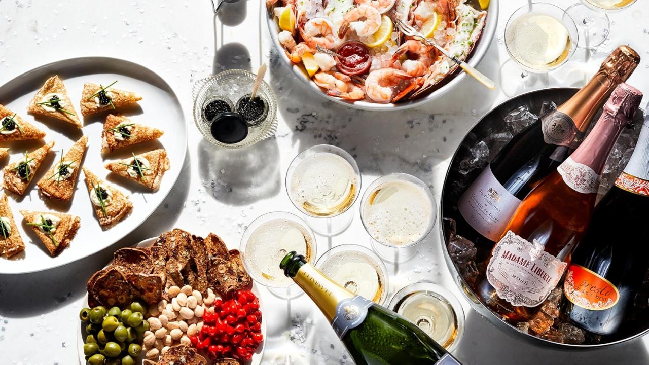 an assorted table of appetizers and champagne