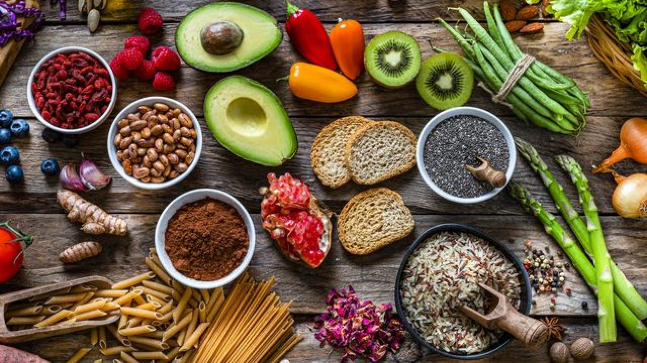 Fruits, vegetables, lentils, and bread on table 