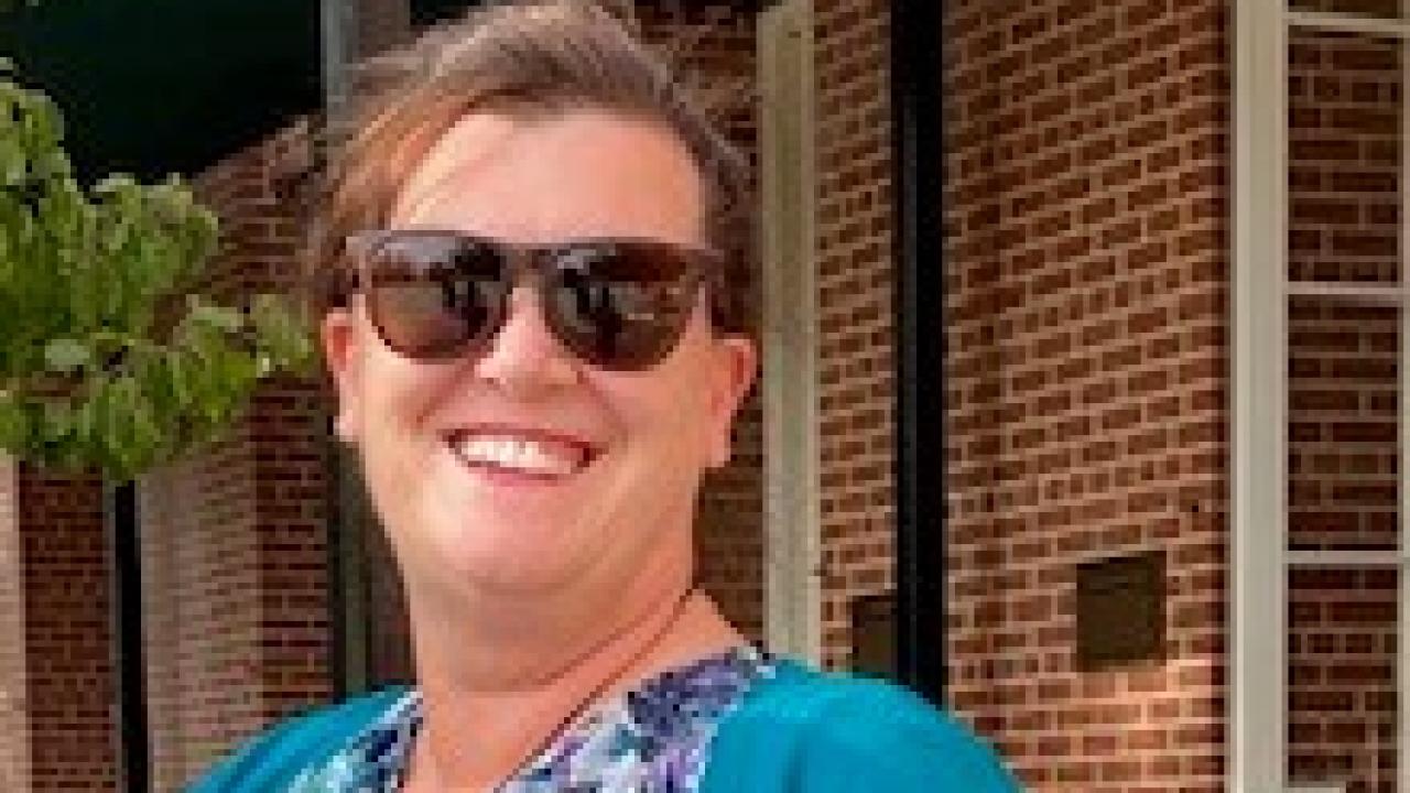Melissa smiling with sunglasses on