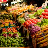 various fruits and vegetables at a stand at Pike Place Market, Seattle