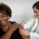 person receiving a flu shot from a medical professional