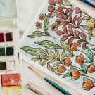 image of watercolor palette and artwork of flowers