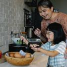 Grandmother and granddaughter cooking together