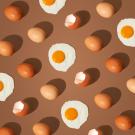 brown eggs and sunny side up eggs on a brown background