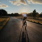 cyclist on the road in the morning sunrise