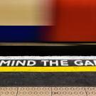 Mind the gap caution text on a train platform
