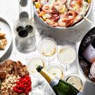 an assorted table of appetizers and champagne
