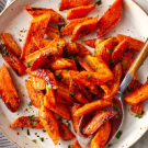a bowl of roasted carrots on a table